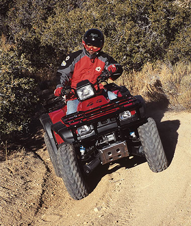 Snowmobile Rider going down slope